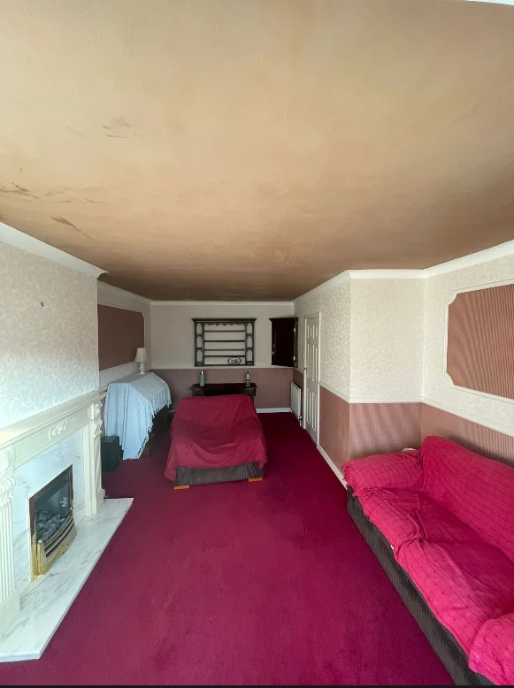 Freshly plastered living room ceiling above covered furniture in Bardsey, near Leeds