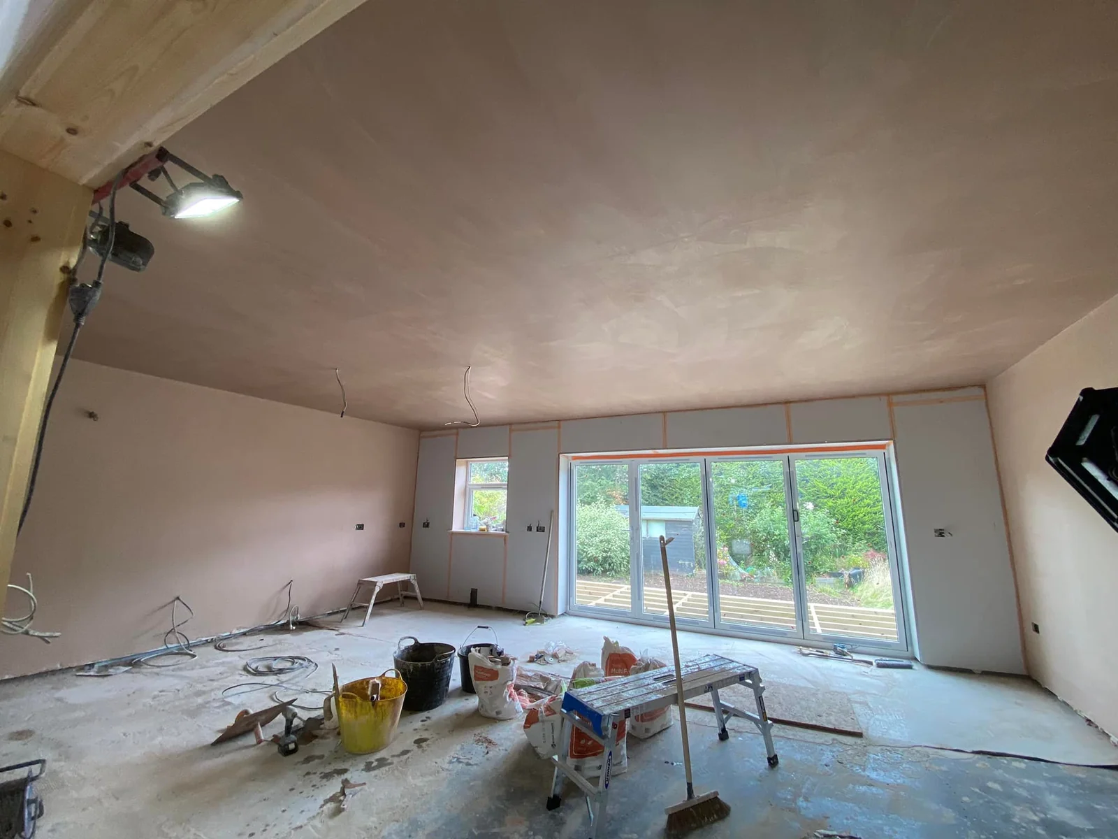 Fresh plastering work on the walls and ceiling of a living room extension in Wetherby, near Leeds