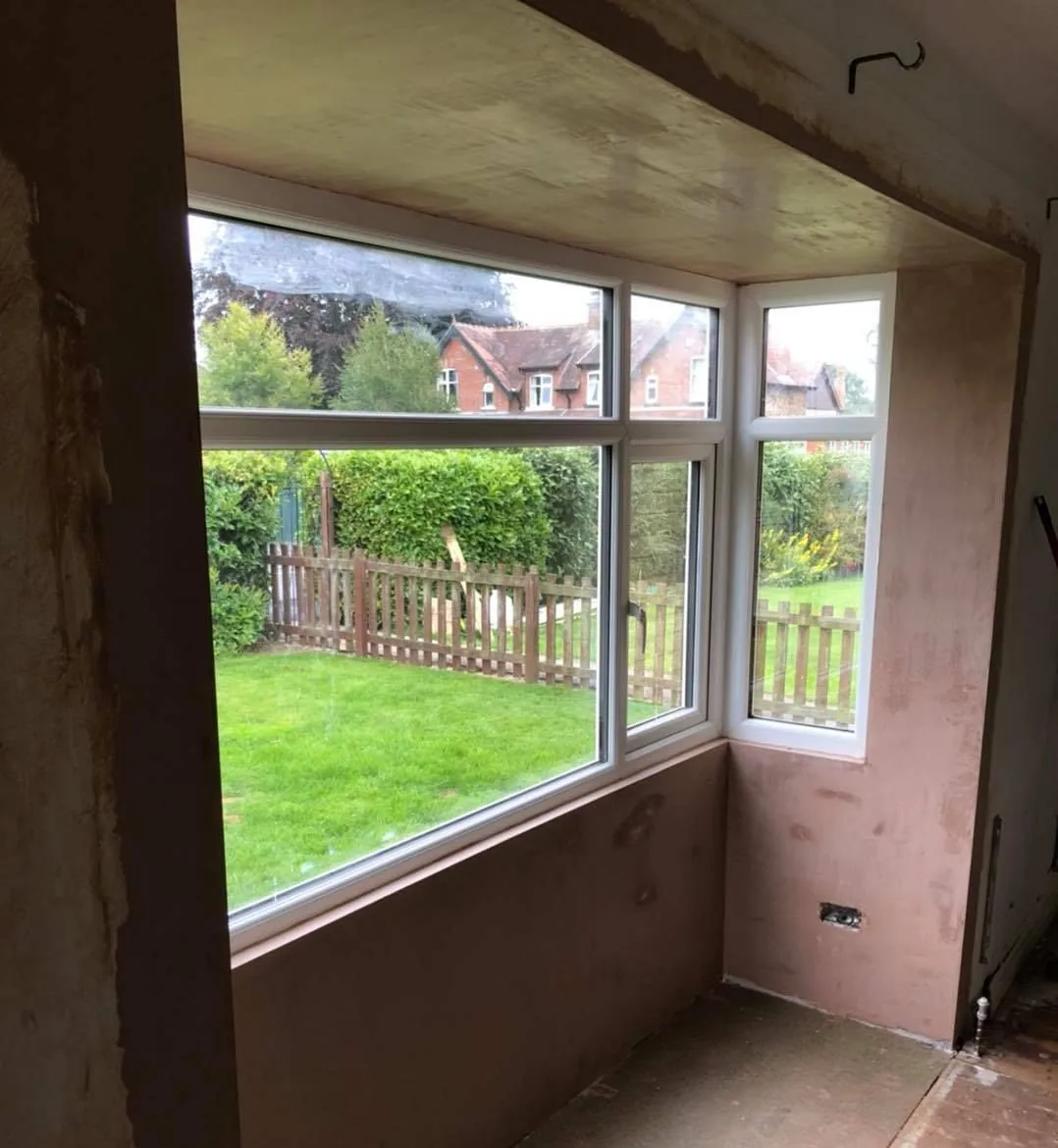 Fresh plaster on bay window reveals and the wall below the window